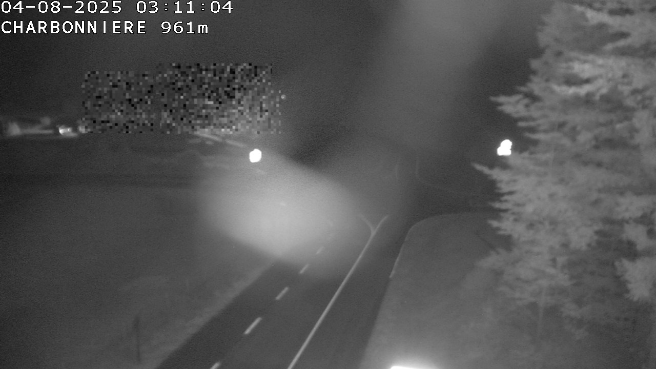 Webcam du col de la Charbonnière dans les Vosges en direction de la station du Champ du feu. Vue sur le D214 et la Tour du Champ du feu. Col de montagne à 961 mètres d'altitude