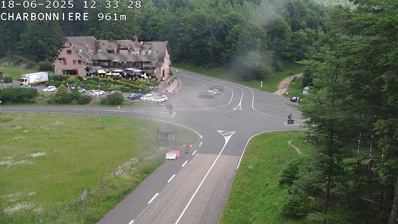 Webcam du col de la Charbonnière dans les Vosges en direction de la station du Champ du feu. Vue sur le D214 et la Tour du Champ du feu. Col de montagne à 961 mètres d'altitude
